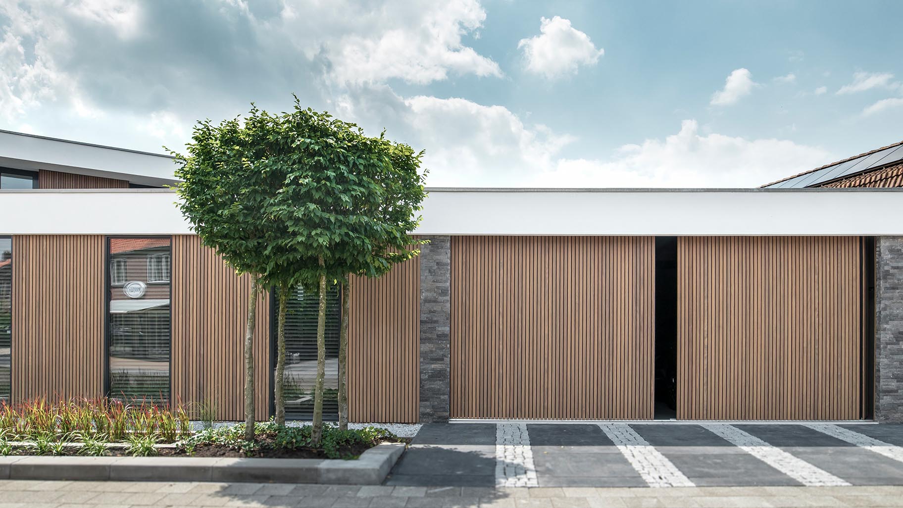 Dubbele houten zijwaartse garagedeur van afrormosia latten - Different Doors