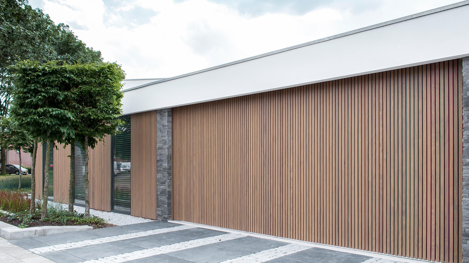 Dubbele houten zijwaartse garagedeur van afrormosia latten - Different Doors