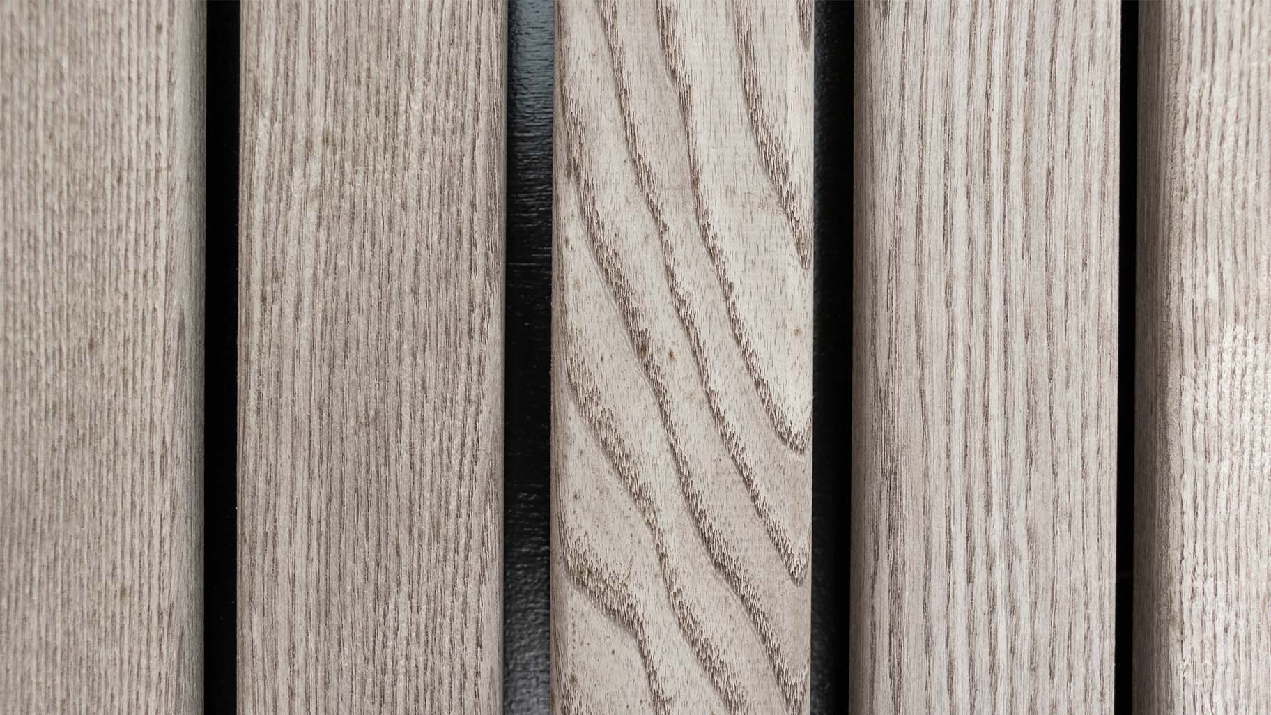 Detail van vergrijsd Essen hout in garagedeur en gevel