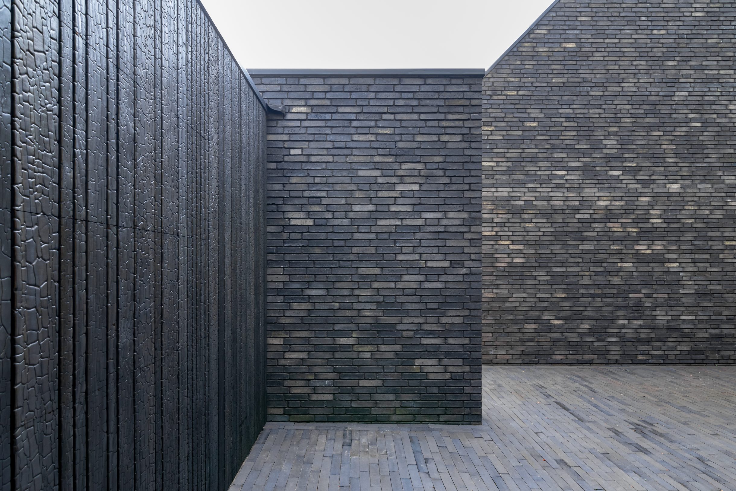 Different Doors Shou Sugi Ban garagedeur volledig verdwenen in moderne gevel