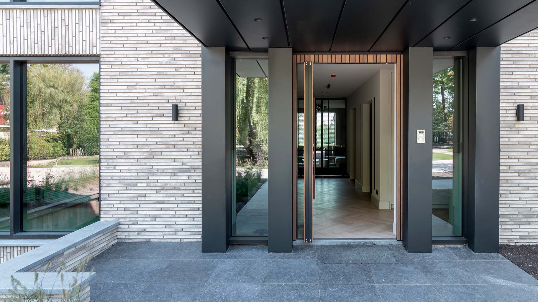 Houten taatsdeur als voordeur van een moderne woning