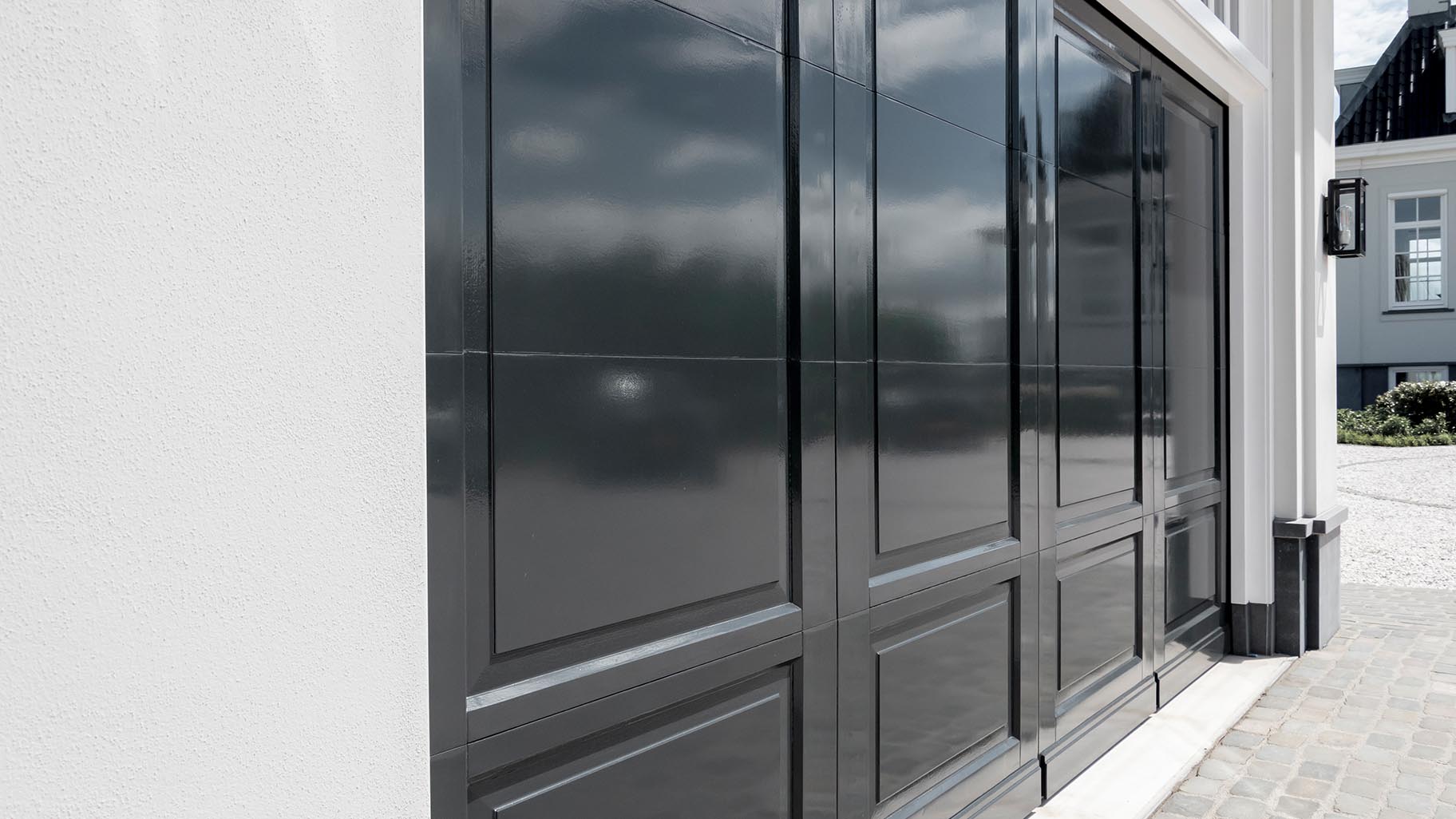 Landgoed met villa en garage met drie houten sectionaaldeuren