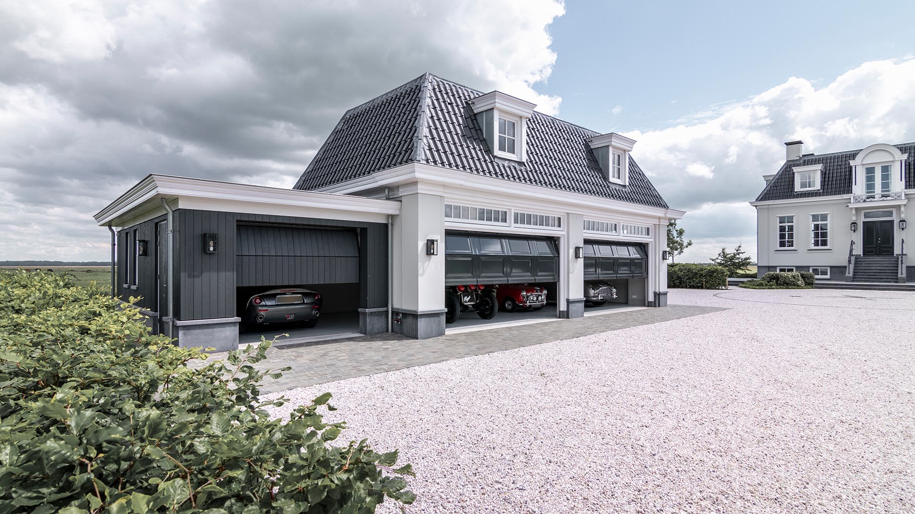 Landgoed met villa en garage met drie houten sectionaaldeuren