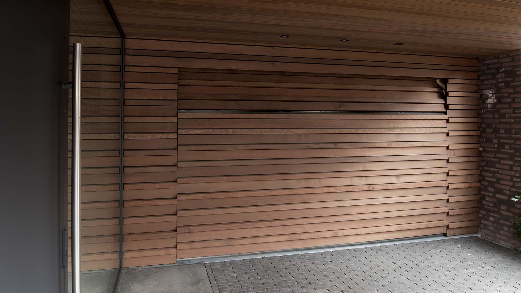 Houten sectionaaldeur bekleed met Red Cedar latten gerealiseerd door different doors