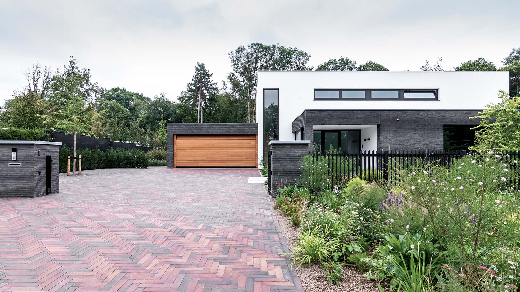 Houten sectionaaldeur van Red Cedar hout bij witte villa